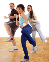Three young people fitness exercising, kicking